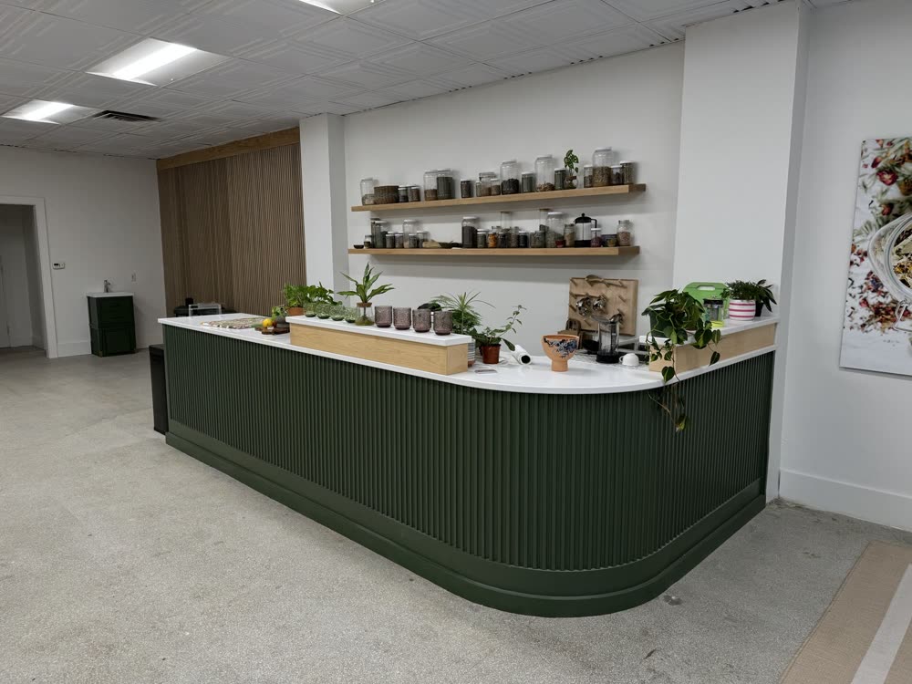 Curved shop counter with green paneling